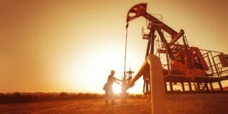 Oil,Worker,Is,Checking,The,Pump,Near,Oil,Derrick,On